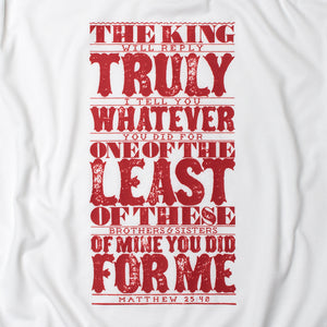 Close up of Matthew 25:40 in bold, textured design printed in red on white t shirt