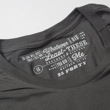 Load image into Gallery viewer, Close up of Matthew 25:40 printed as the tag on a charcoal gray t shirt