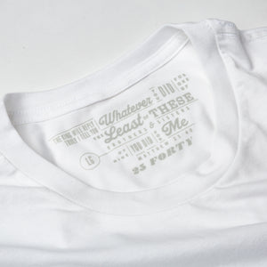 Close up of 25 Forty Christian t shirt tag printed in gray on white tee