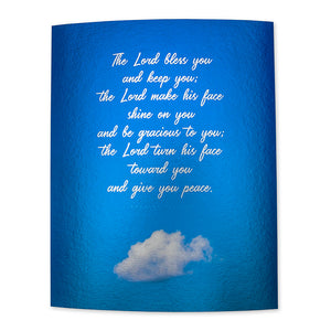 Metallic print of Numbers 6:24-26 in white handwritten script on blue sky background with one cloud