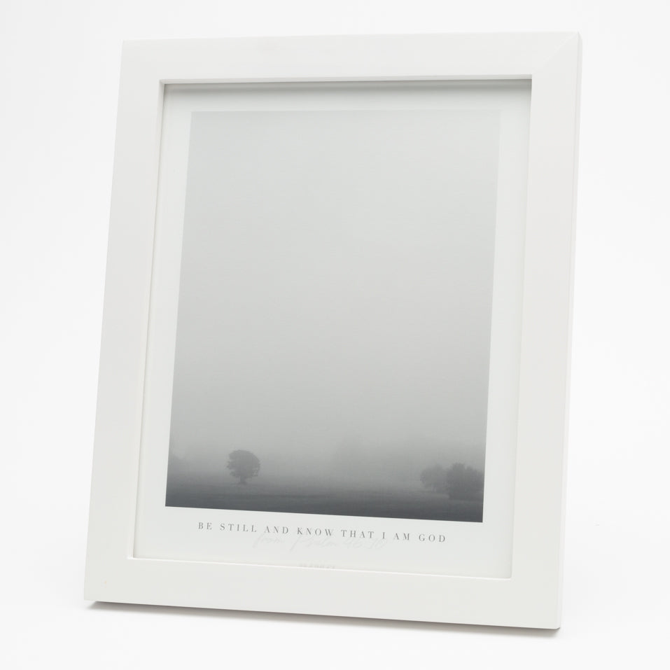 Black and white print of tree in fog with Psalm 46:10 at the bottom in a white frame