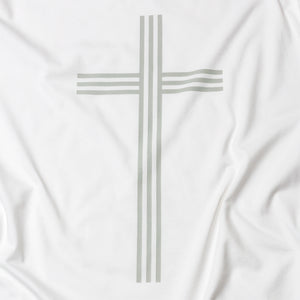 Close up of simple, elegant and linear Christian cross in gray on white t shirt
