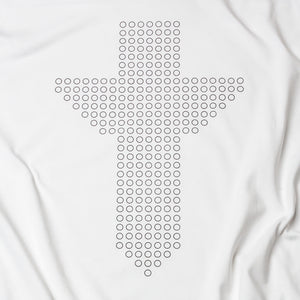 Close up view of black Christian cross consisting of circles on a white t shirt