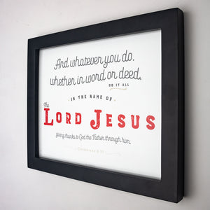Colossians 3:17 printed in red, gray and tan on white fine art paper in black frame