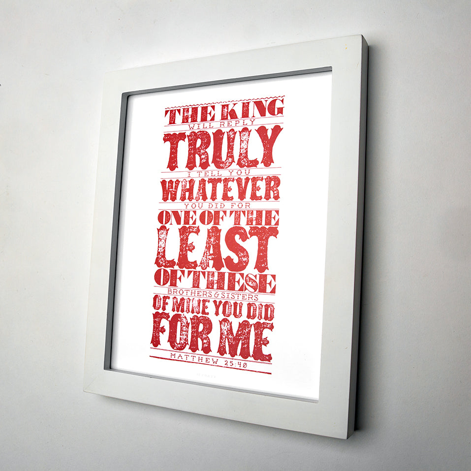 Matthew 25:40 printed in red in bold, rustic and western style on white art paper in white frame.
