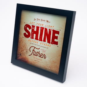 Metallic photo print with Matthew 5:16 in textured type with wooden background in black frame