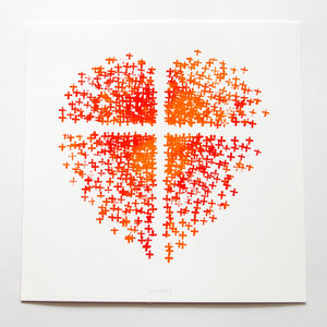Orange and red heart made up of crosses with a white cross in the middle on white paper.