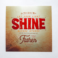 Load image into Gallery viewer, Metallic photo print with Matthew 5:16 in textured type with wooden background